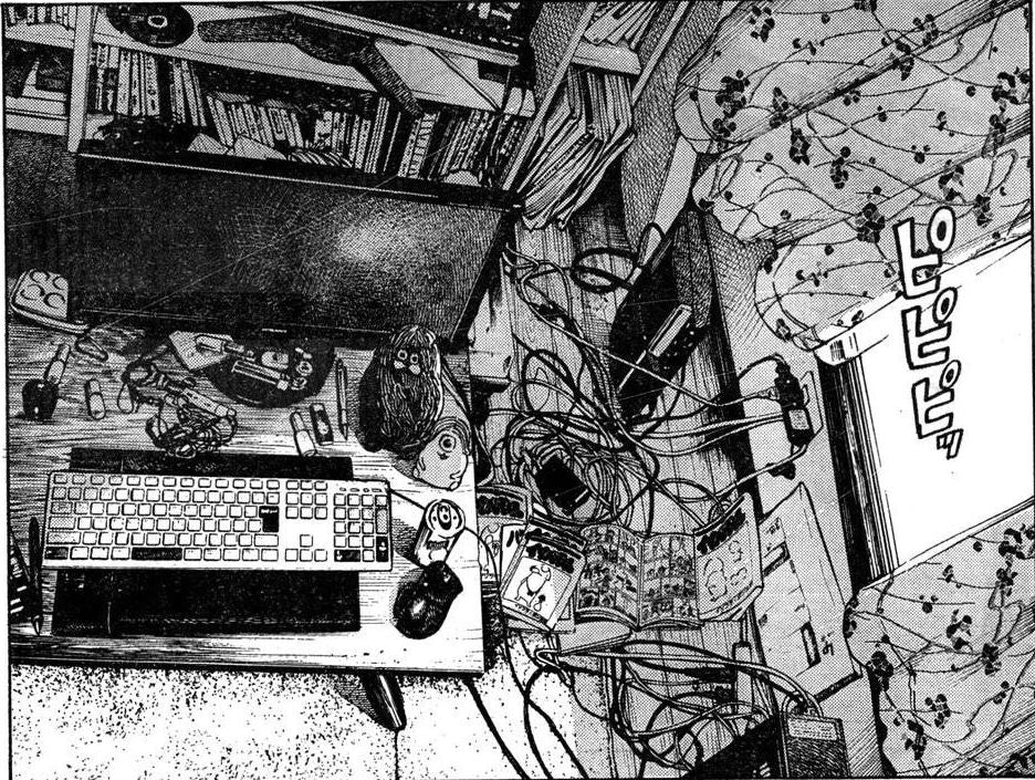 a black-and-white manga drawing of a cluttered computer desk beside a bed