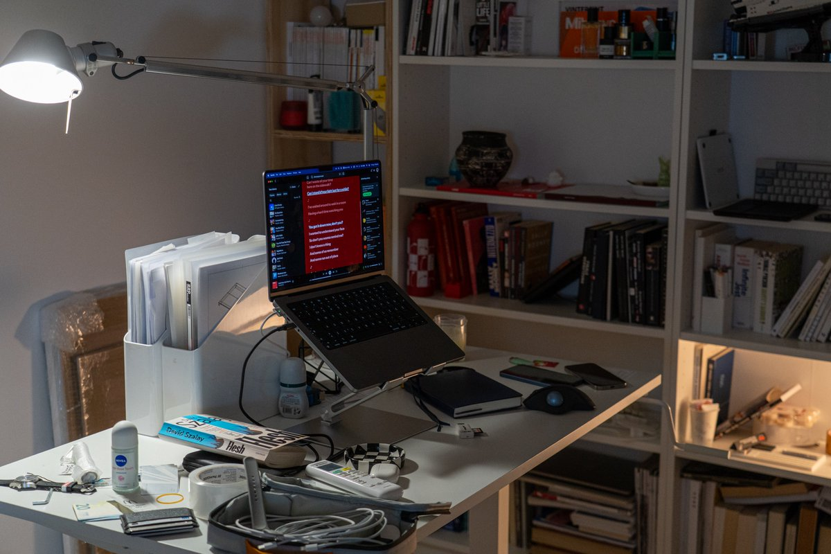Laptop workstation beneath an articulated desk lamp