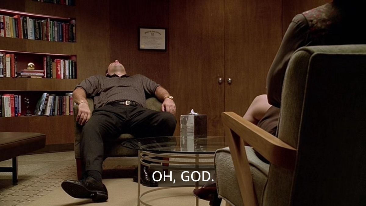 Film still of a man reclining in a therapist's office saying oh god