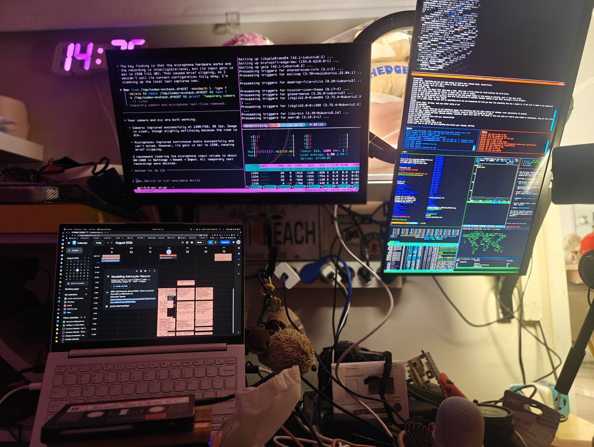 Busy workstation with multiple terminal-filled monitors